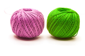 colored yarn balls green and pink isolated on white 