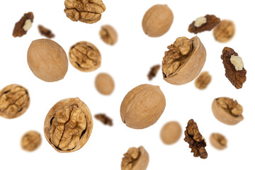 Falling walnuts isolated on a white background with clipping path as package design element and advertising. Top view.