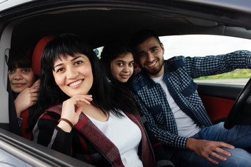 Happy woman with family in the car - 351336113