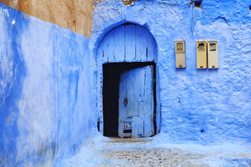View of the old door in Medina quarter in Chefchaouen, Morocco. The city, also known as Chaouen is noted for its buildings in shades of blue and that makes Chefchaouen very attractive to visitors.
