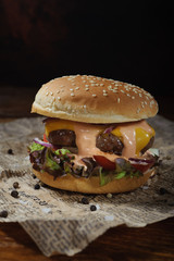 Juicy Burger on the table on a dark background