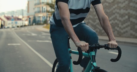 Young hipster man riding bike