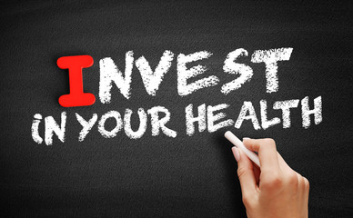 Invest In Your Health text on blackboard, concept background