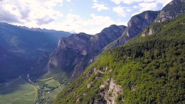 Stunning Aerial view of the Alps in Trentino, Northern Italy. Camera dollys past magnificent, lush green mountains