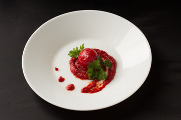 The fresh tomato with young herbs. A dish of fresh vegetables.