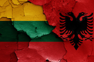 flags of Lithuania and Albania painted on cracked wall
