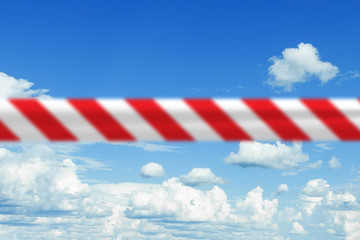 Quarantine and prohibition concept with sky, clouds and warning tape