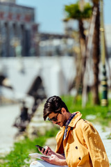 Modern businessman with looking on his cellphone
