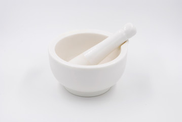 white mortar with pestle for grinding spices and medicines on a white background made of natural stone kitchen accessory