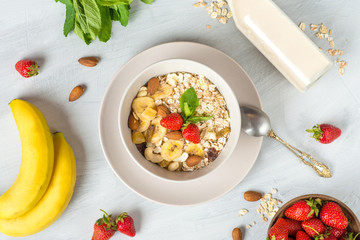 muesli with strawberries, banana and almond milk, vegan breakfast