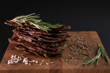 Close-up of a piece of meat on a wooden Board with spices. Restaurant menu, a series of photos of different dishes
