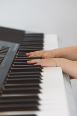 Fototapeta na wymiar Little girl playing a synthesizer