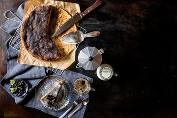 Apple cinnamon tart on a dark table. Female hand takes a piece of pie. Eat homemade cake. Advertising booklet for the bakery. View from above
