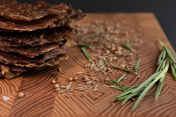 Close-up of a piece of meat on a wooden Board with spices. Restaurant menu, a series of photos of different dishes