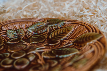 Vintage plate with patterns on a background of hay