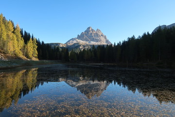 Peaceful reflection of the mountain at the Lago d'Antorno in the Dolomites