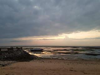 sunrise time at sanur beach in bali with the remarkable view of boat and coral