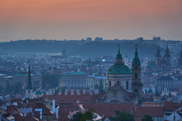 Fototapeta na wymiar Cityscape of old town with may towers of churches of Prague, capitol of Czech republic during the blue hour before sunset. Main building is Saint Nicolas church on the Lesser Town under the castle.