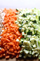 Chopped mushroom, carrot, zucchini and leek on a cutting board. Selective focus.