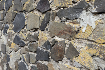 Texture of a stone wall as background. Perspective side view of wall.