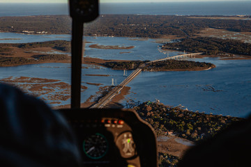 Aerial view of island and ocean with blue water from a helicopter.