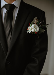 Boutonniere on a groom wearing a tux on wedding day. 