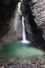 Turquoise waterfall streaming through the rocks in Slovenia