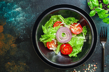 Healthy salad, leaves mix salad (mix micro greens, cucumber, tomato other ingredients) keto or paleo diet food background copy space 