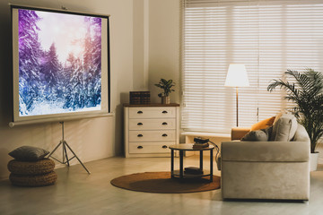Stylish room with modern video projector and comfortable sofa - obrazy, fototapety, plakaty