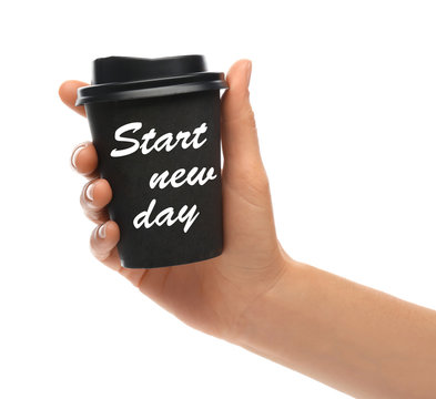 Woman holding paper coffee cup with phrase START NEW DAY on white background, closeup