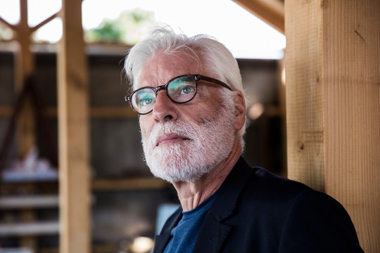 Portrait Of Bearded Senior Man With White Hair Looking At Distance