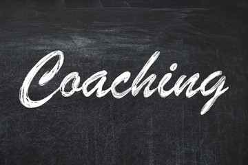 Obraz premium Adult learning. Word Coaching written on black chalkboard