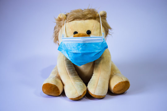 Protective medical face mask wearing stuffed lion toy