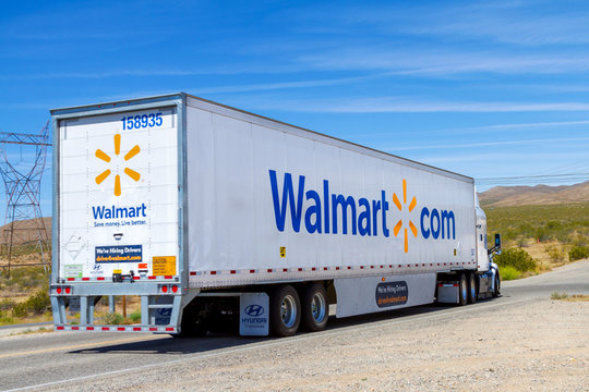 Apple Valley, CA / USA – May 16, 2020: A Walmart semi truck trailer on a Mojave Desert road in Apple Valley, California. 