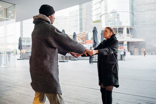 Young couple holding hands in the city - Powered by Adobe