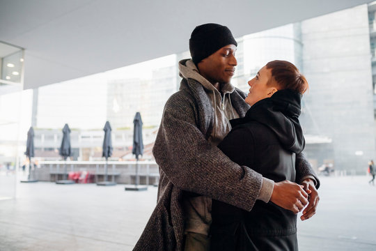 Young couple embracing in the city - Powered by Adobe