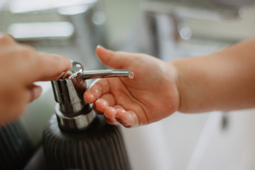 close up of a young man washing his hands