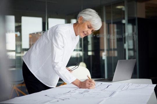 Portrait of architect working on construction plan in office