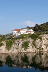 Fototapeta na wymiar amazing house in the mountains over the lake with tiled roof