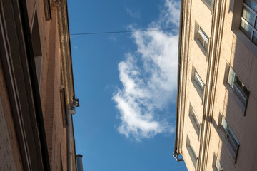 2 common old building tops at close distance against blue sky. Low angle view.