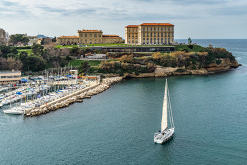 A sailboat leaving the Marseille Old Port under the Palais du Pharo, France.