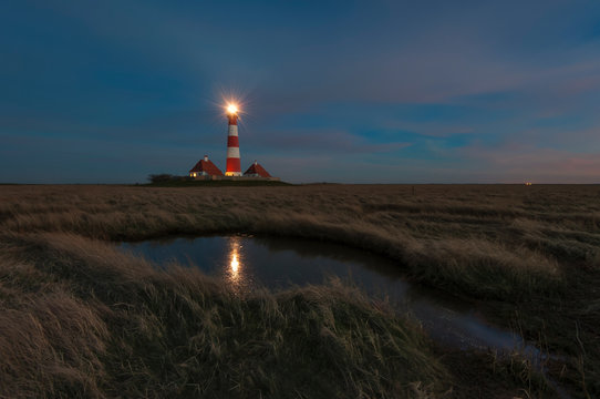 Germany, Schleswig-Holstein, North Sea Coast, View of Westerheversand Lighthouse at night