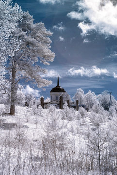 Infrared photography. Surreal landscape, beautiful trees through which you can see the dome of the church, our beautiful world in the spectrum of infrared camera which we do not see the usual eye.