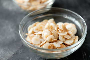 Mini cereal pancakes, Little dutch poffertjes. little round pancakes in transparent bowl on grey background. New trendy dessert in social media. Funny food for kids 