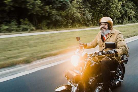 Portrait of happy man riding motorbike