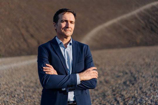 Portrait of a confident mature businessman on a disused mine tip
