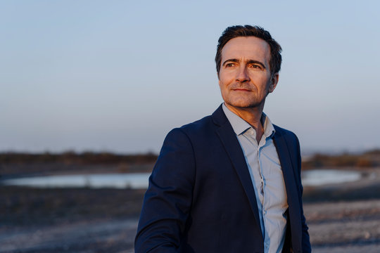 Portrait of a confident mature businessman on a disused mine tip