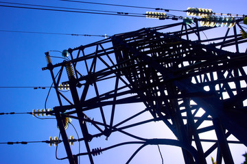 metal tower of a high voltage power line with insulators and wires