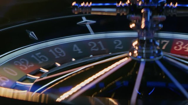 This close-up video showcases a roulette wheel spinning in a casino in slow motion.