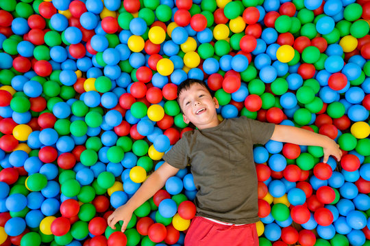 Smiling boy lying in ball pit